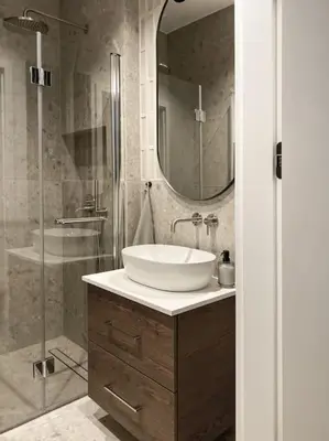 a bathroom with a sink and a glass shower at Apartament BonHaus WiślaneTarasy in Kraków