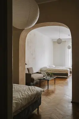 a living room with two beds and a table at HERE Apartments in Kraków