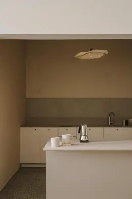 a kitchen with a white counter and a sink at HERE Apartments in Kraków