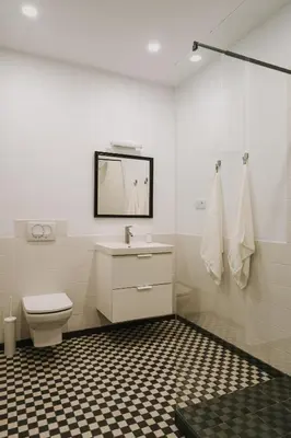 a bathroom with a toilet and a sink and a mirror at HERE Apartments in Kraków