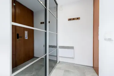 a glass door in a room with a hallway at Yellow Window Apartment in Kraków