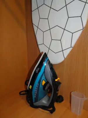 a backpack sitting on the floor next to a vase at Yellow Window Apartment in Kraków