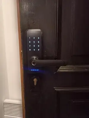 a black door with a cell phone on it at Yellow Window Apartment in Kraków