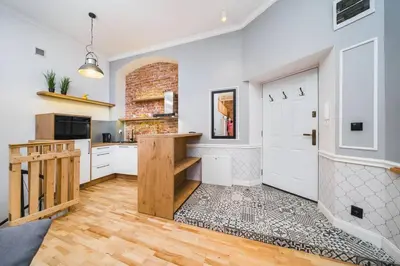 a kitchen with white cabinets and a white door at Vélo Apartment, High Standard, TV, WiFi in Kraków