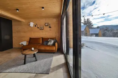 a living room with a couch and a table at Bocianie Gniazdo w Rabce in Rabka-Zdroj
