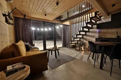 a living room with a couch and a table at Bocianie Gniazdo w Rabce in Rabka-Zdroj