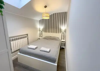 a bedroom with a bed with two towels on it at Z&M apartments - Cracow Old Town in Kraków