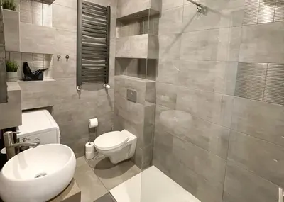 a bathroom with a white toilet and a shower at Z&M apartments - Cracow Old Town in Kraków