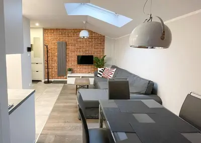 a living room with a couch and a table at Z&M apartments - Cracow Old Town in Kraków