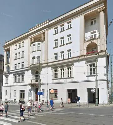a group of people crossing a street in front of a building at Z&M apartments - Cracow Old Town in Kraków