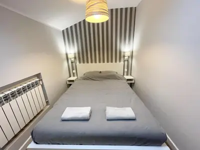 a bedroom with a bed with two towels on it at Z&M apartments - Cracow Old Town in Kraków