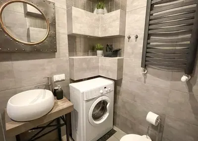a bathroom with a washing machine and a sink at Z&M apartments - Cracow Old Town in Kraków