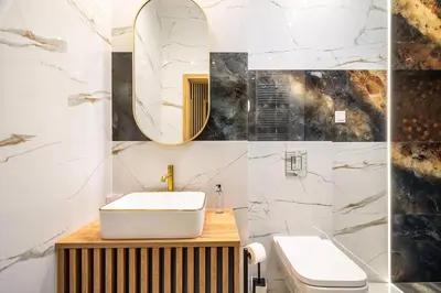 a bathroom with a white sink and a mirror at RentPlanet - Apartamenty Kościuszki in Kraków