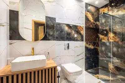 a bathroom with a sink and a toilet and a mirror at RentPlanet - Apartamenty Kościuszki in Kraków