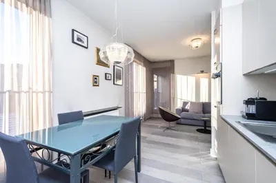 a kitchen and dining room with a blue table and chairs at RentPlanet - Apartament Lubicz in Kraków