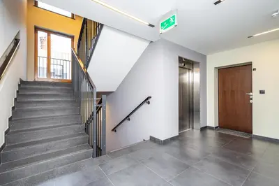 an empty hallway with stairs and a door at RentPlanet - Apartament Lubicz in Kraków