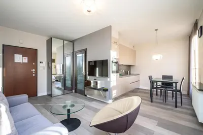 a living room with a couch and a table at RentPlanet - Apartament Lubicz in Kraków