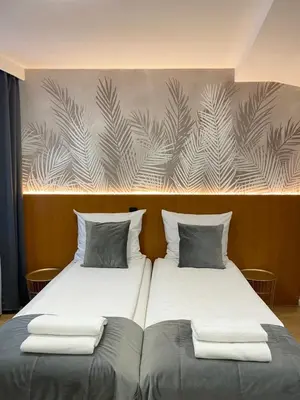 two beds sitting next to each other in a room at Cube House Aparthotel in Kraków