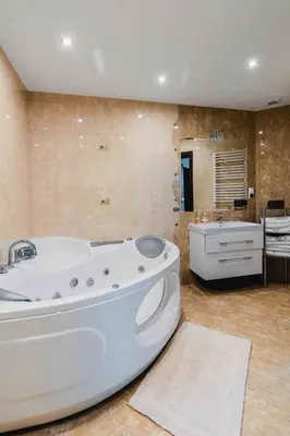 a large bathroom with a tub and a sink at Willa Łysa Góra Limanowa in Limanowa