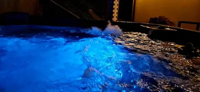 a hot tub filled with blue water in a room at Willa Łysa Góra Limanowa in Limanowa