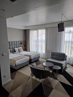 a bedroom with a bed and a couch and a chair at Apartament 338 ulica Lwowska 1 in Kraków