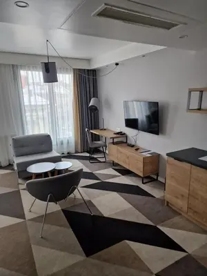 a living room with a tv and a couch and a table at Apartament 338 ulica Lwowska 1 in Kraków