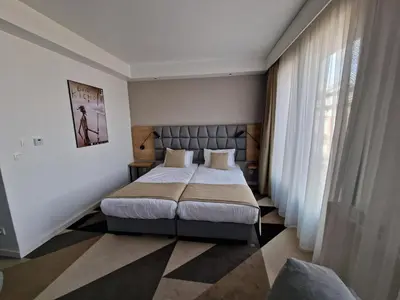 a bedroom with a large bed and a window at Apartament 338 ulica Lwowska 1 in Kraków