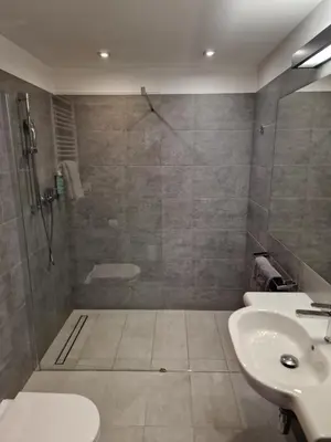 a bathroom with a shower and a toilet and a sink at Apartament 338 ulica Lwowska 1 in Kraków
