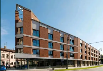 a large brick building on the side of a street at Apartament 338 ulica Lwowska 1 in Kraków