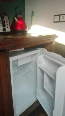 a white refrigerator with its door open in a kitchen at Z widokiem- Old Town in Kraków