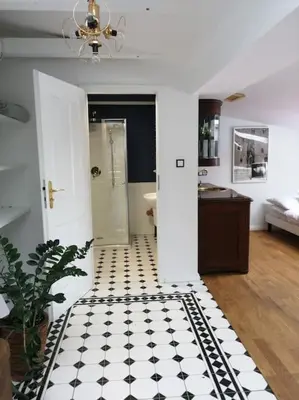 a bathroom with a black and white tiled floor at Z widokiem- Old Town in Kraków