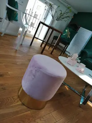 a white stool sitting on the floor in a living room at Z widokiem- Old Town in Kraków