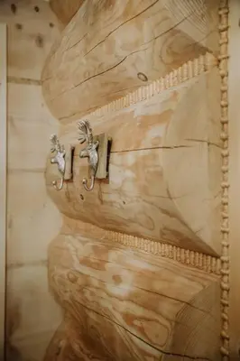 a wooden wall with two metal hooks on it at Dom na Zapotoczu. Góralski dom na wyłączność na szczycie skały. in Kasinka Mala