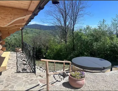 a patio with a table and a picnic table at Dom na Zapotoczu. Góralski dom na wyłączność na szczycie skały. in Kasinka Mala
