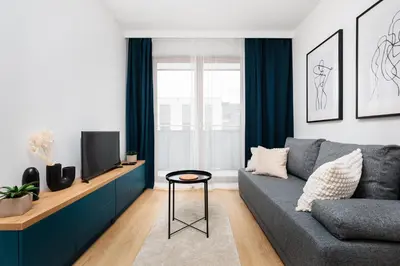 a living room with a couch and a tv at Colorful Cracovia Apartments - by Upstairs in Kraków