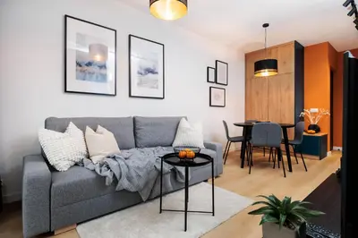 a living room with a couch and a table at Colorful Cracovia Apartments - by Upstairs in Kraków
