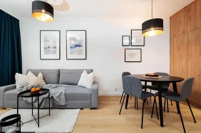 a living room with a couch and a table at Colorful Cracovia Apartments - by Upstairs in Kraków