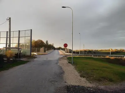 a road with a stop sign and a street light at Noclegi nad S-ką in Miechów