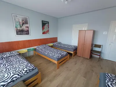 a room with three beds and a cabinet at Noclegi nad S-ką in Miechów