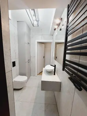 a bathroom with a sink and a toilet in it at Nowe mieszkanie Kraków, bezpłatny parking, AWG APARTMENTS in Kraków