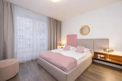 a bedroom with a bed and a large window at Blue and Green Apartment with Bright Pink Bedroom in Kraków by Noclegi Renters in Kraków