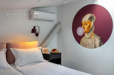 a bedroom with a painting of a woman with a balloon at Spacious apartment 11 PAX, Vistula River - Fragola Apartments in Kraków