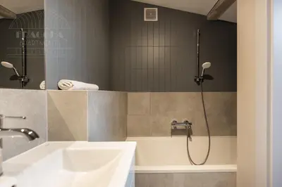 a bathroom with a tub and a sink and a shower at Spacious apartment 11 PAX, Vistula River - Fragola Apartments in Kraków
