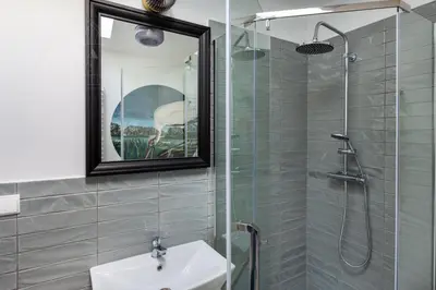a bathroom with a shower and a sink and a mirror at Spacious apartment 11 PAX, Vistula River - Fragola Apartments in Kraków