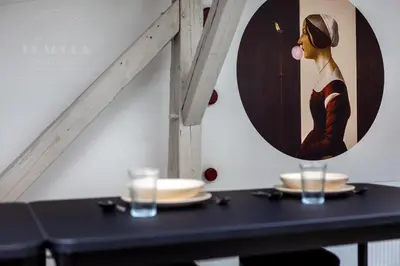 a black table with a painting of a woman at Spacious apartment 11 PAX, Vistula River - Fragola Apartments in Kraków
