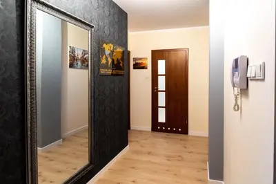 a mirror in a hallway next to a door at Verona Apartament 115, 69m2, Terrace, Garage in Kraków