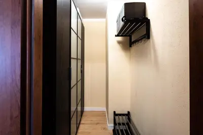 a hallway with a staircase with a television on the wall at Verona Apartament 115, 69m2, Terrace, Garage in Kraków