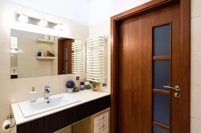 a bathroom with a sink and a mirror at Verona Apartament 115, 69m2, Terrace, Garage in Kraków