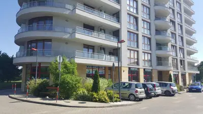 a large building with cars parked in front of it at Verona Apartament 115, 69m2, Terrace, Garage in Kraków