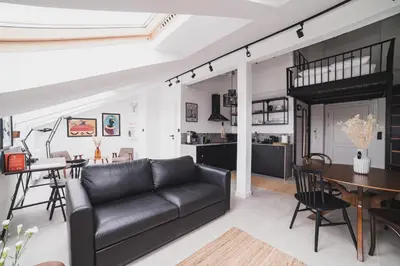a living room with a couch and a table at Vitrum Apartments in Kraków